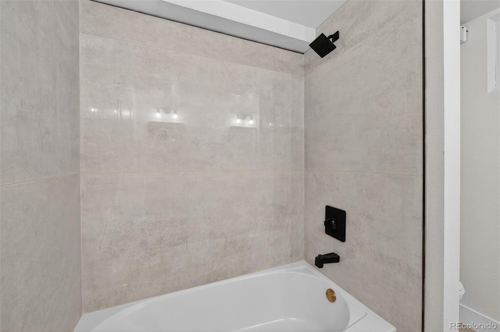 1856 South Steele Street Denver, CO 80210 - Photo 22 of 34 a bathroom with a bathtub