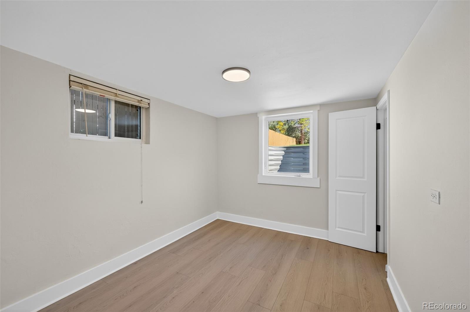 1856 South Steele Street Denver, CO 80210 - Photo 24 of 34 a view of an empty room with window and wooden floor