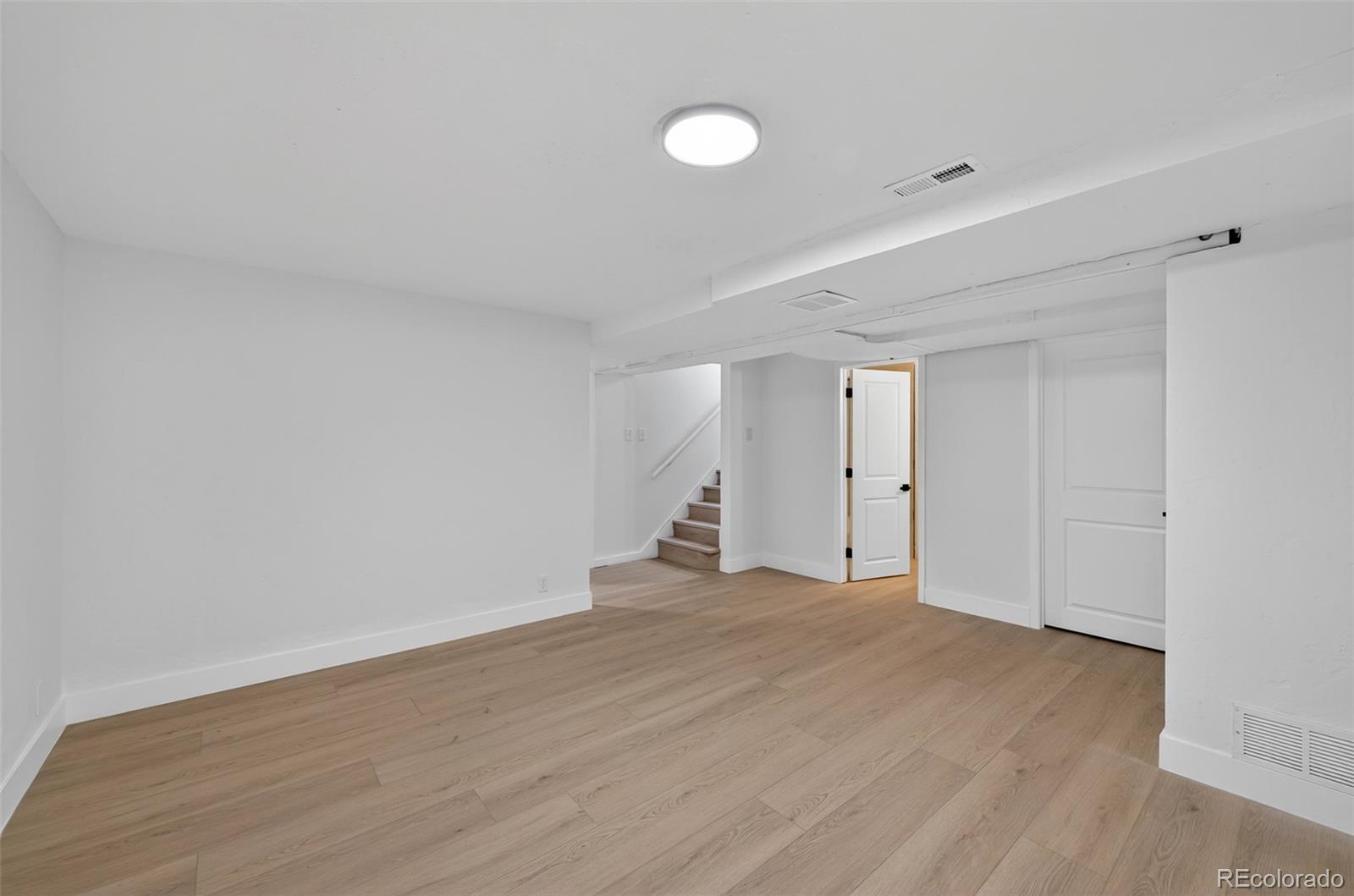 1856 South Steele Street Denver, CO 80210 - Photo 28 of 34 a view of empty room with wooden floor and fan