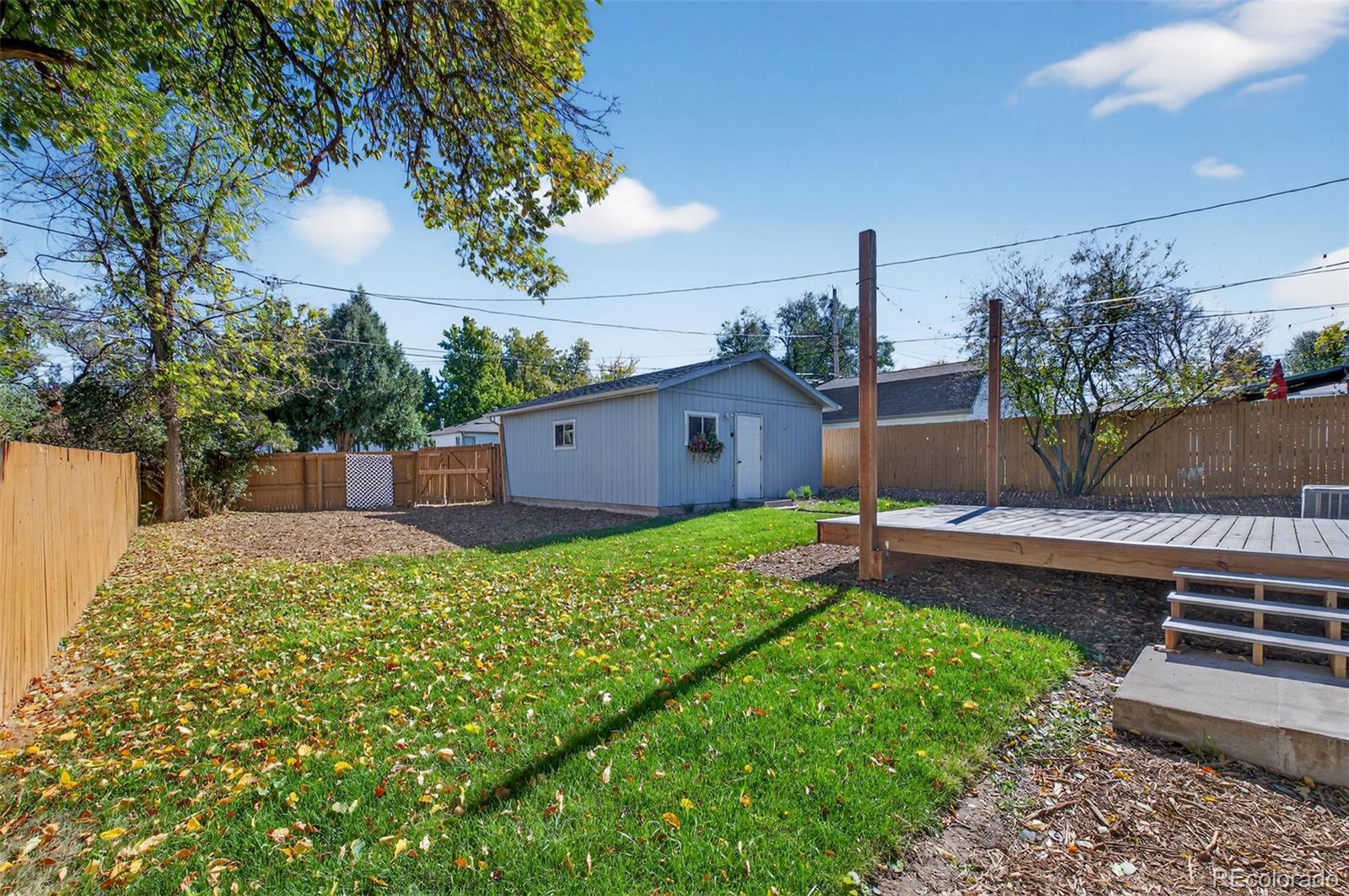 1856 South Steele Street Denver, CO 80210 - Photo 33 of 34 a backyard of a house with lots of green space