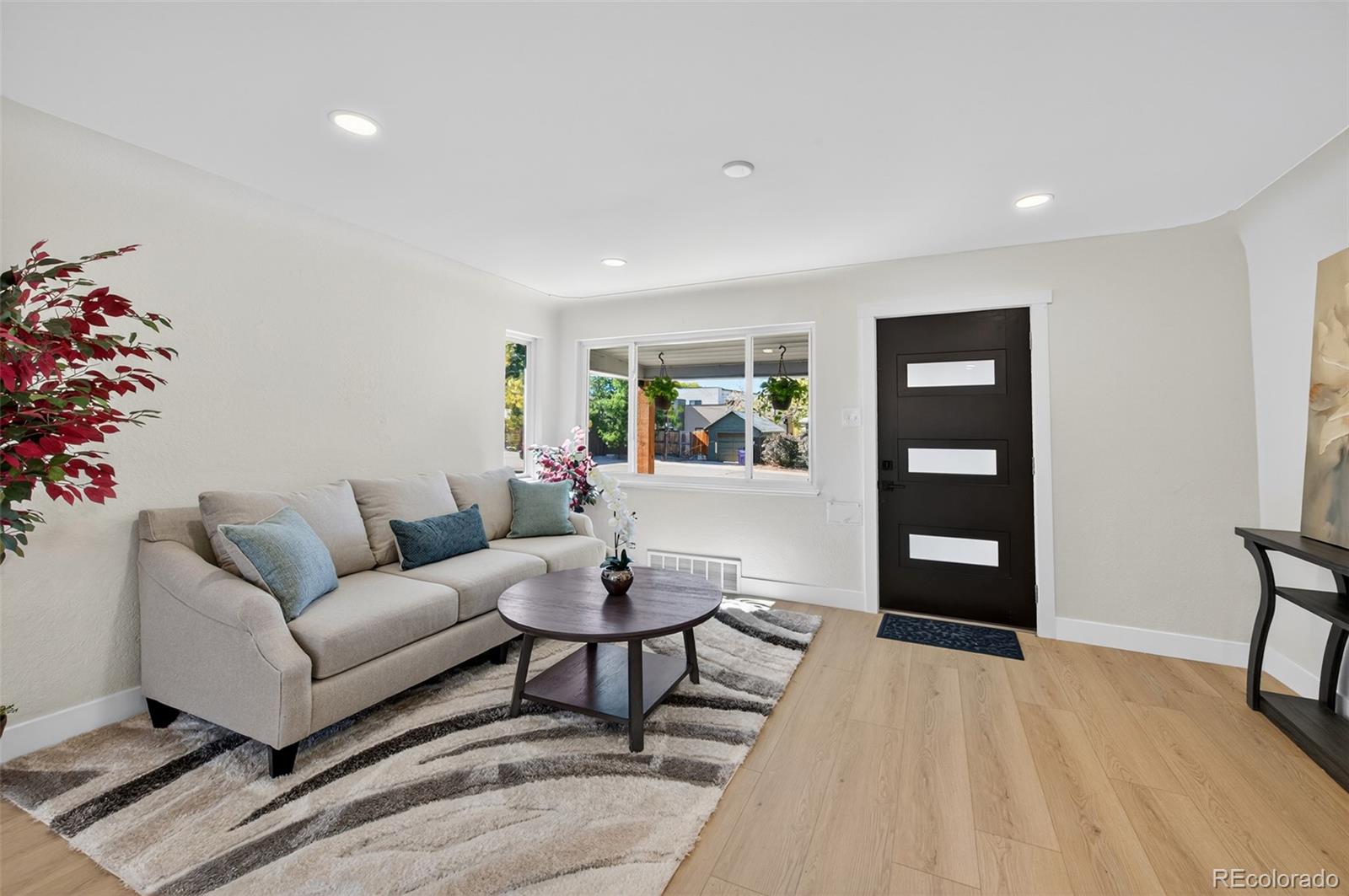 1856 South Steele Street Denver, CO 80210 - Photo 6 of 34 a living room with furniture and wooden floor
