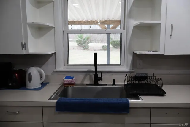 a view of a kitchen with a sink stainless steel appliances and cabinets