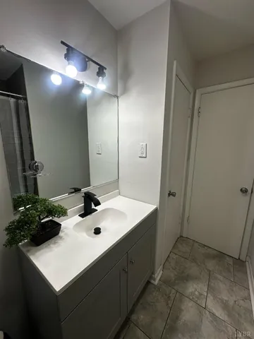 a view of a house with a yard and large trees