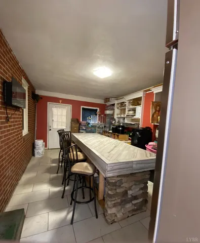 a kitchen with stainless steel appliances granite countertop a sink a stove a microwave a refrigerator and cabinets