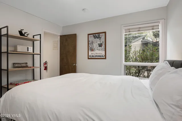 a bedroom with a large bed and a window