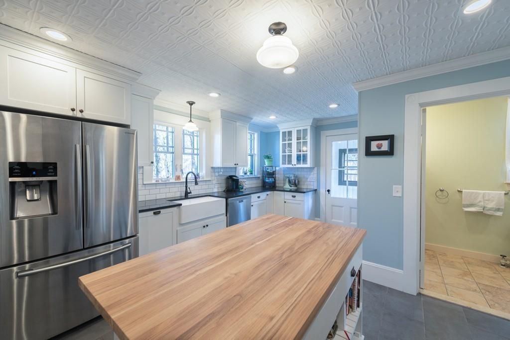 187 Pleasant Street Framingham, MA 01701 - Photo 11 of 39 a kitchen with refrigerator and windows