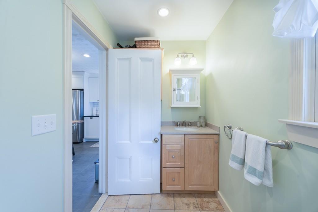 187 Pleasant Street Framingham, MA 01701 - Photo 13 of 39 a bathroom with a bathtub sink vanity and mirror