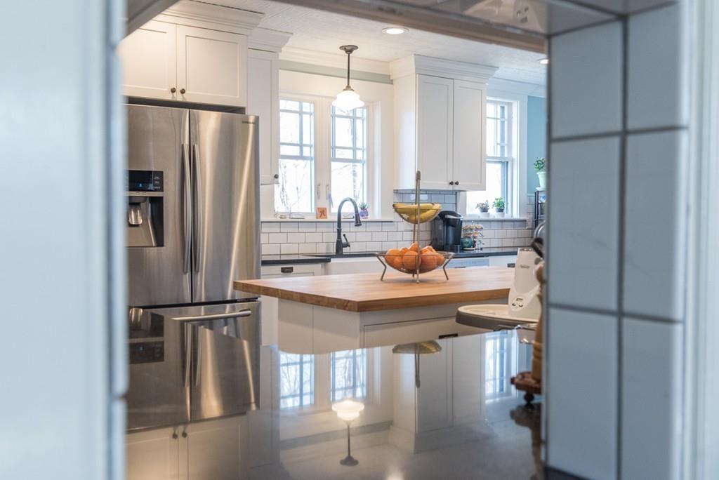 187 Pleasant Street Framingham, MA 01701 - Photo 18 of 39 a kitchen with stainless steel appliances granite countertop a refrigerator a sink and white cabinets
