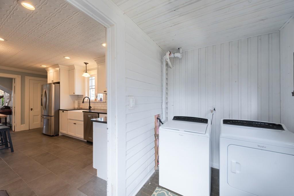 187 Pleasant Street Framingham, MA 01701 - Photo 19 of 39 a kitchen with a refrigerator a sink and dishwasher a oven with white cabinets