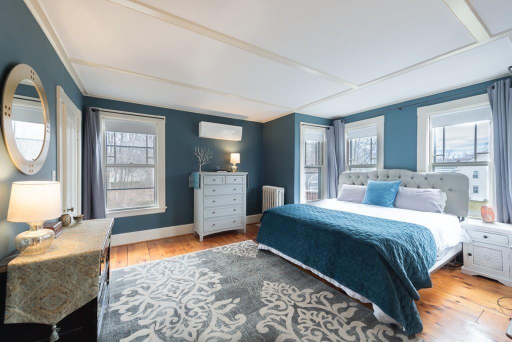 187 Pleasant Street Framingham, MA 01701 - Photo 24 of 39 a bedroom with a bed a dresser and mirror