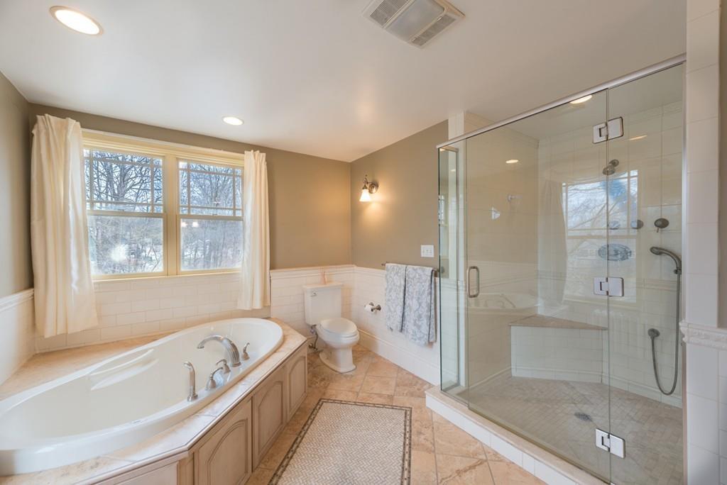 187 Pleasant Street Framingham, MA 01701 - Photo 26 of 39 a spacious bathroom with a granite countertop tub shower and mirror