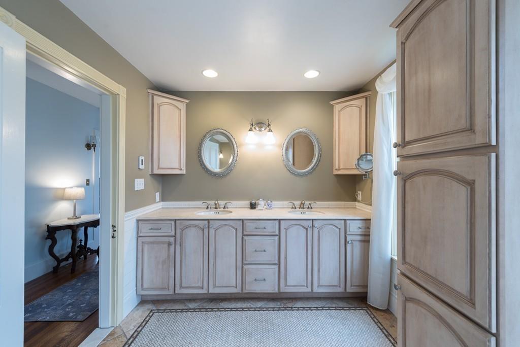 187 Pleasant Street Framingham, MA 01701 - Photo 27 of 39 a kitchen with a sink a clock and cabinets