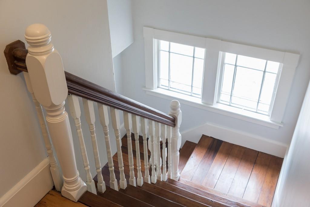187 Pleasant Street Framingham, MA 01701 - Photo 32 of 39 a view of staircase with white walls and a window