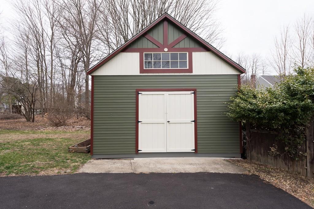 187 Pleasant Street Framingham, MA 01701 - Photo 37 of 39 a front view of a house with a yard and garage