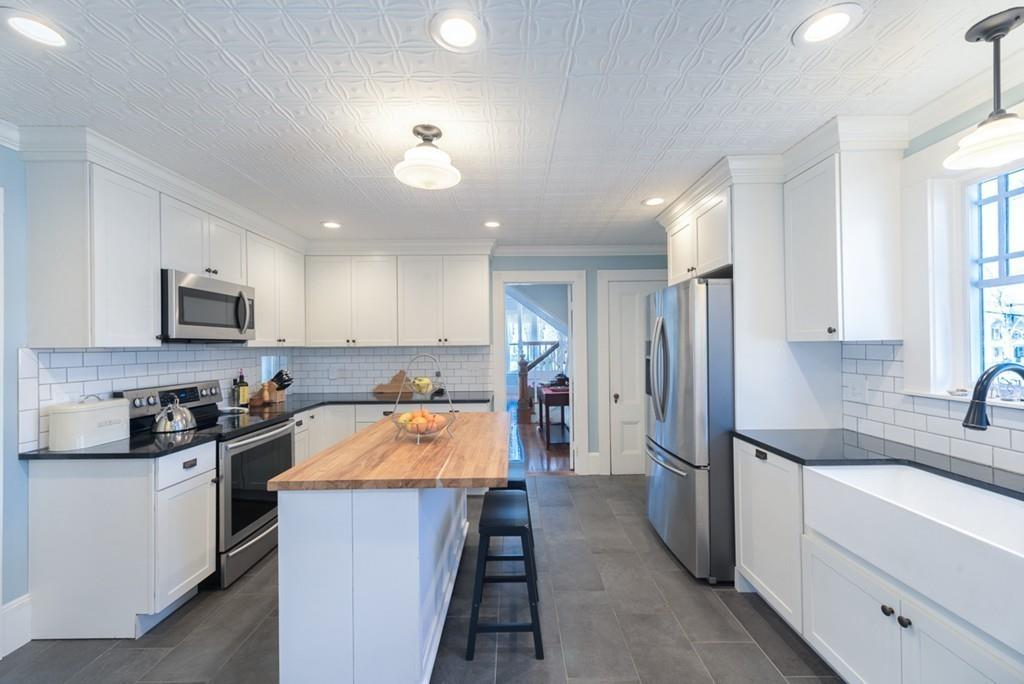 187 Pleasant Street Framingham, MA 01701 - Photo 10 of 39 a kitchen with stainless steel appliances granite countertop a sink stove and refrigerator