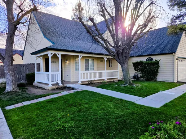 a front view of a house with a garden and plants