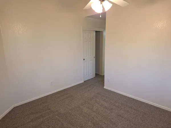 a view of an empty room and a lamp