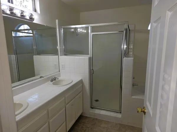 a bathroom with a double vanity sink and mirror