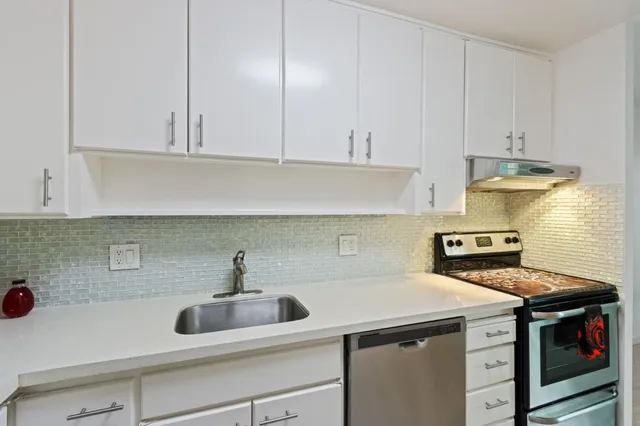 a kitchen with a sink and cabinets