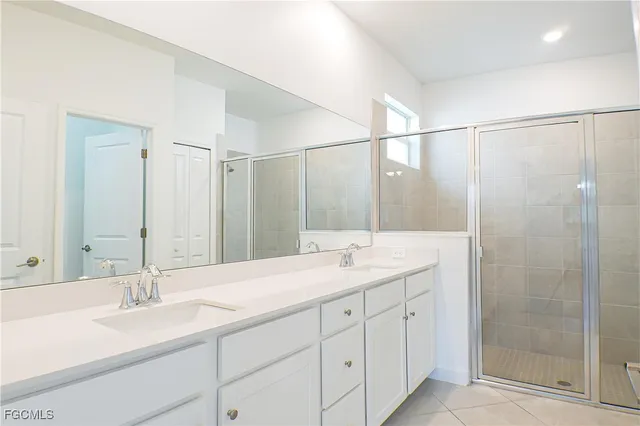 a bathroom with double sink and a mirror