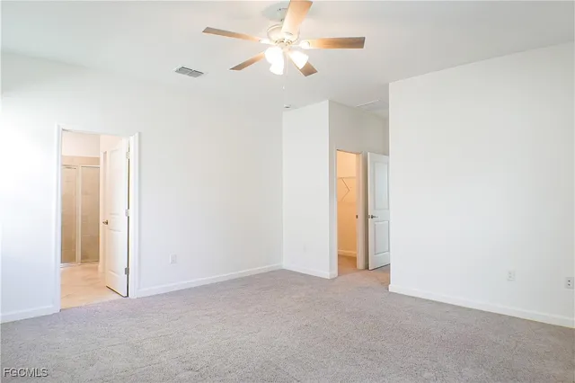 a view of a room with a ceiling fan and a window