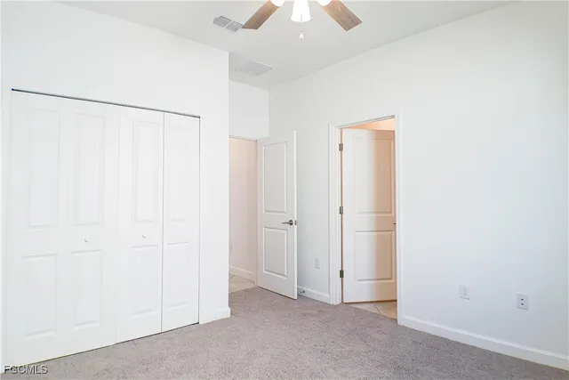 an empty room with a ceiling fan