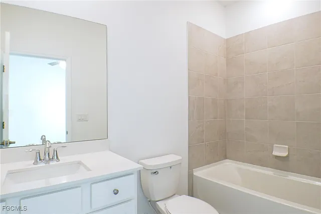 a bathroom with a sink toilet vanity and bathtub