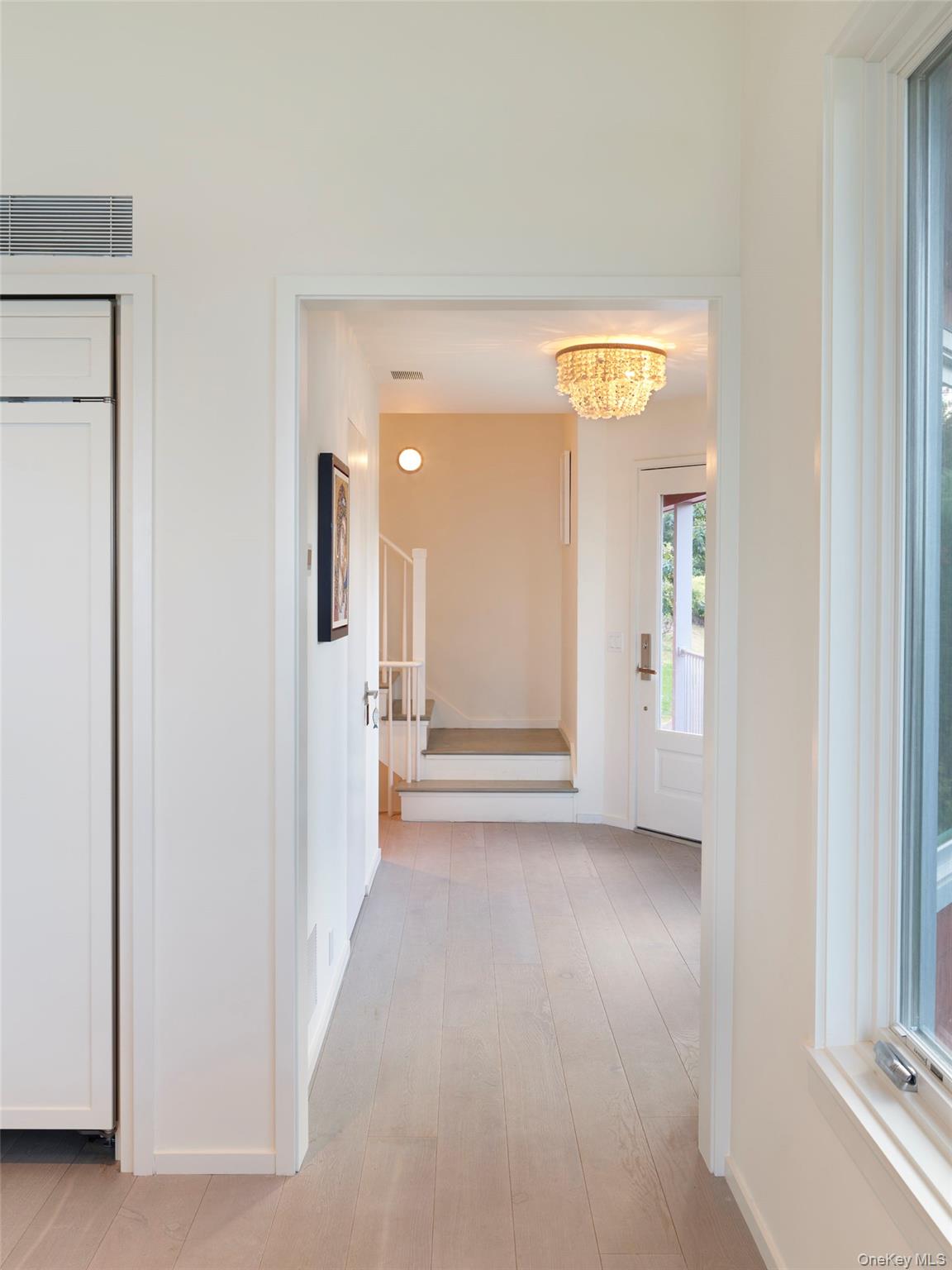 2 Sun Court Hampton Bays, NY 11946 - Photo 13 of 35 a view of a hallway with wooden floor