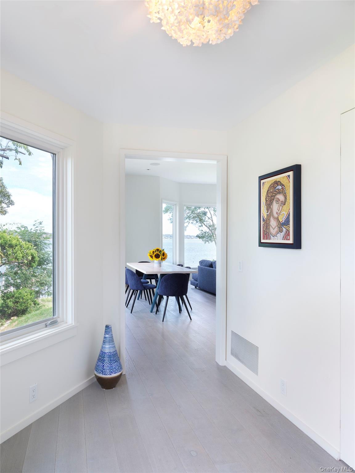 2 Sun Court Hampton Bays, NY 11946 - Photo 14 of 35 a dining room with furniture and a chandelier