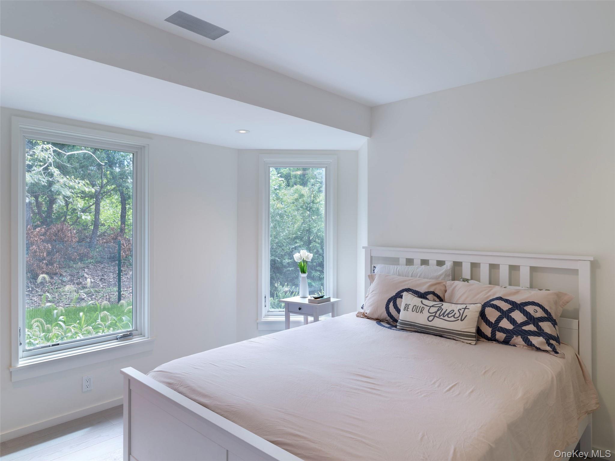 2 Sun Court Hampton Bays, NY 11946 - Photo 17 of 35 a bedroom with a bed and a window