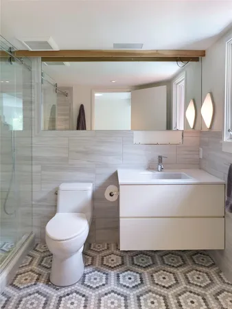 a bathroom with a toilet sink and mirror