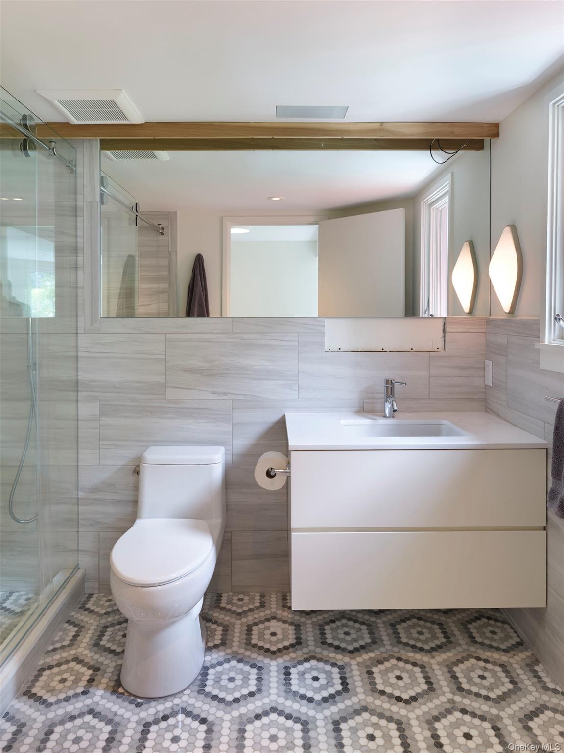 2 Sun Court Hampton Bays, NY 11946 - Photo 18 of 35 a bathroom with a toilet sink and mirror