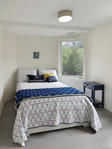 a bedroom with a bed and window