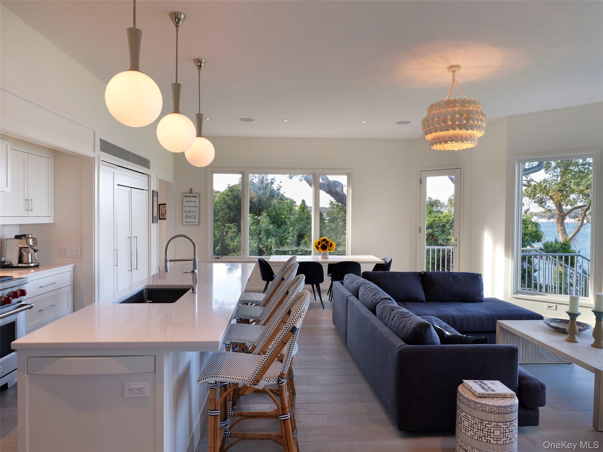 2 Sun Court Hampton Bays, NY 11946 - Photo 31 of 35 a view of a dining room with furniture wooden floor and chandelier