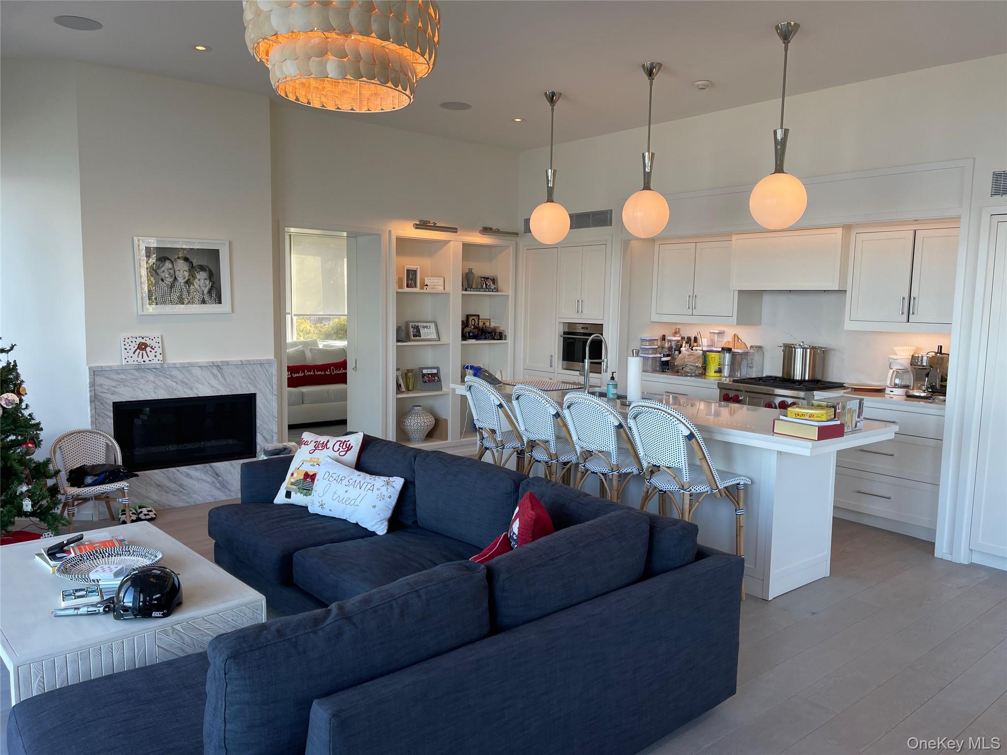 2 Sun Court Hampton Bays, NY 11946 - Photo 7 of 35 a living room with furniture kitchen view and a chandelier