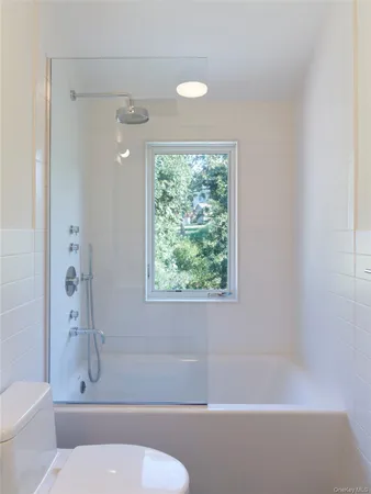 a bathroom with a toilet and a shower
