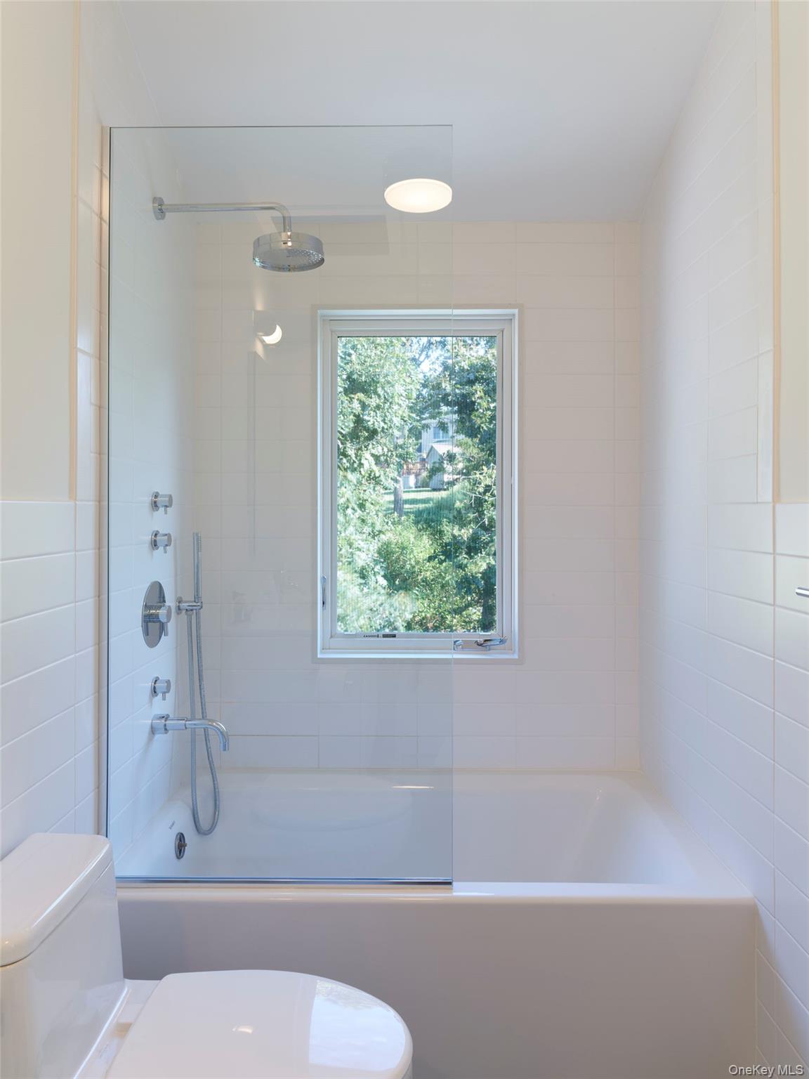 2 Sun Court Hampton Bays, NY 11946 - Photo 10 of 35 a bathroom with a toilet and a shower