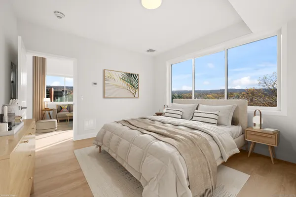 a bedroom with a large bed and a large window