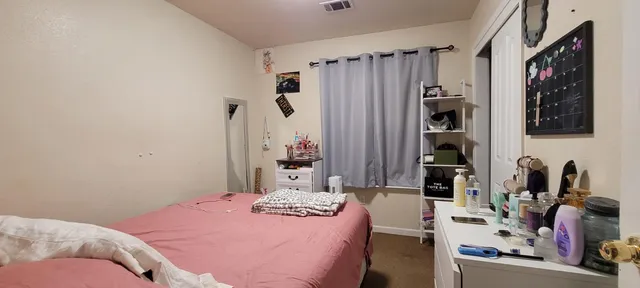 a bedroom with a bed and a window