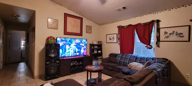 a kitchen with a table chairs refrigerator and cabinets