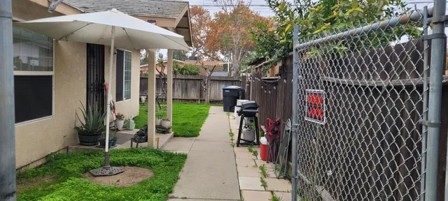 a view of a house with backyard and sitting area