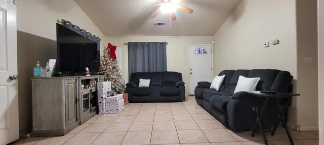 a living room with furniture and a flat screen tv