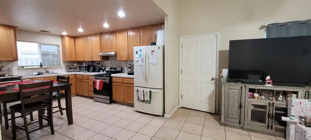 a kitchen with stainless steel appliances a refrigerator and a stove top oven