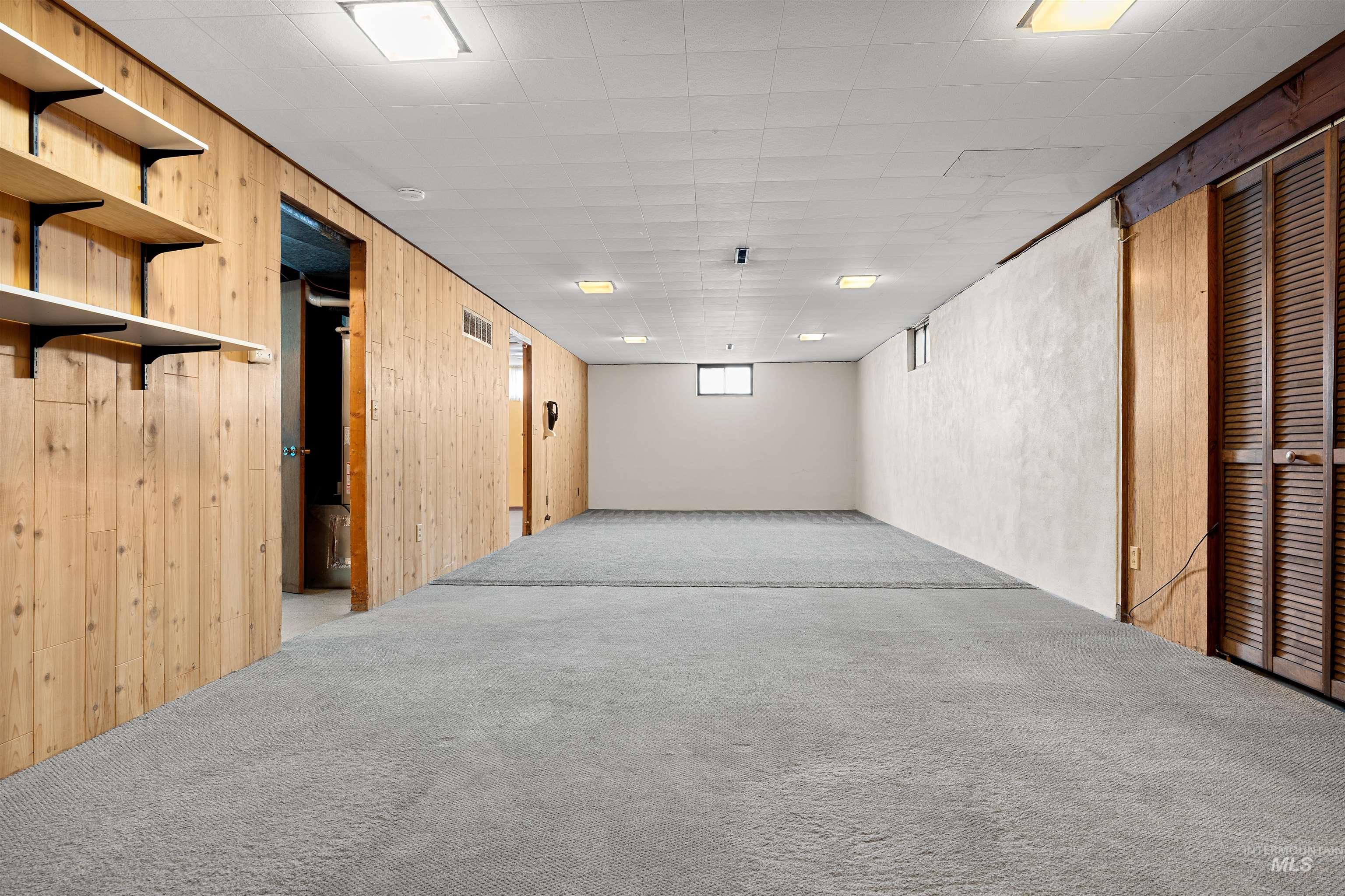 1148 Webster Street Clarkston, WA 99403 - Photo 23 of 29 Below grade area featuring carpet floors and wooden walls