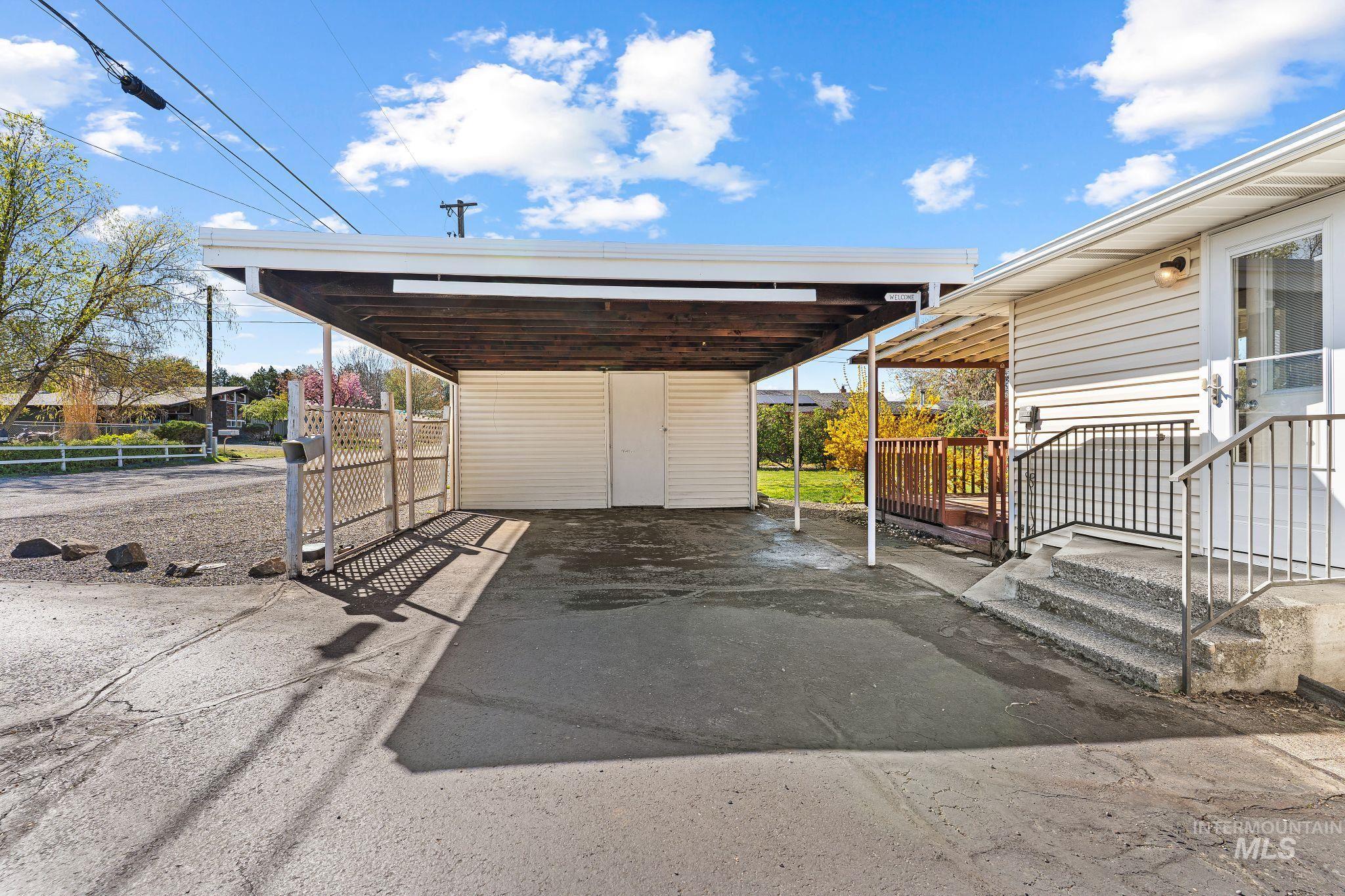 1148 Webster Street Clarkston, WA 99403 - Photo 25 of 29 View of parking featuring asphalt driveway and a carport