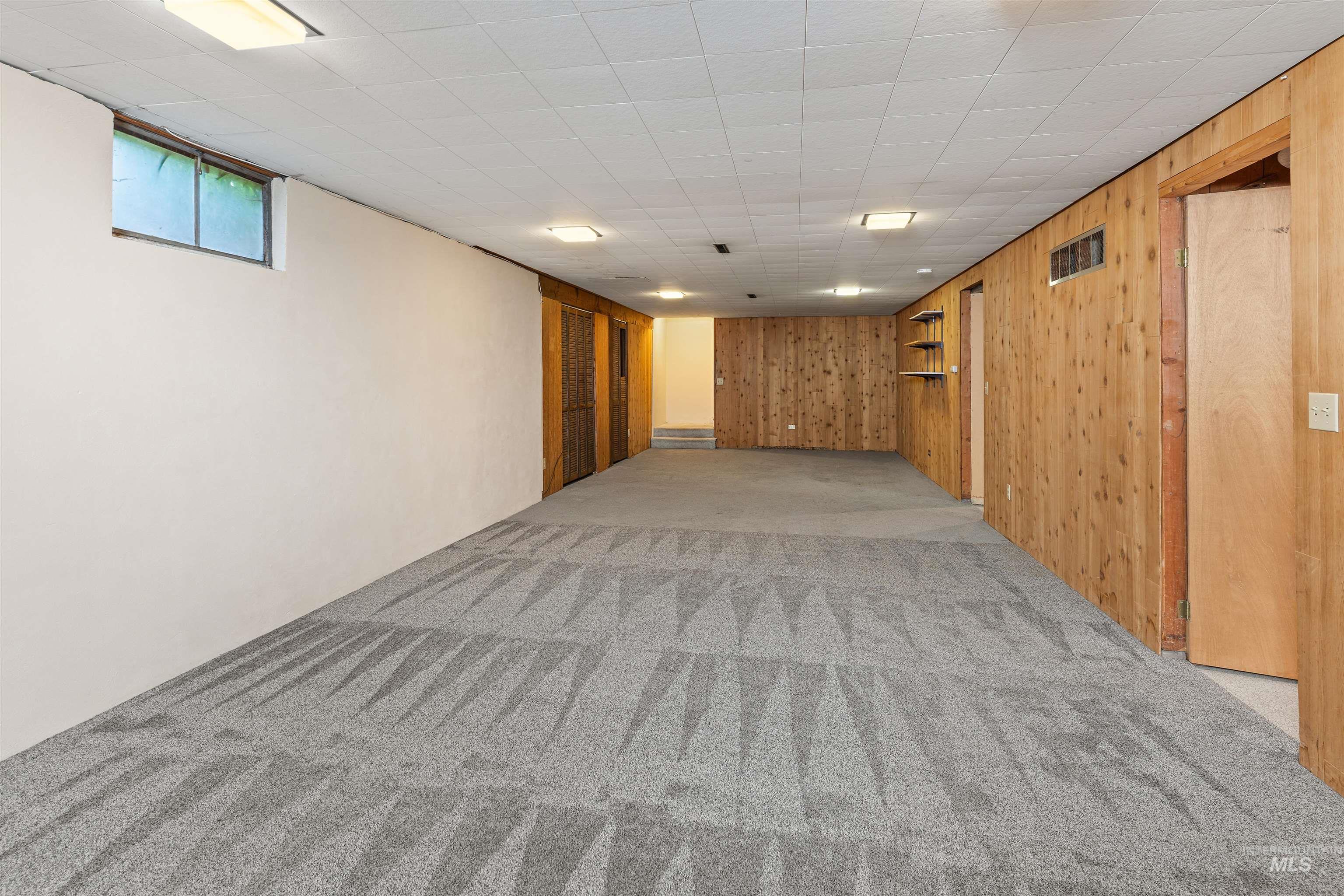1148 Webster Street Clarkston, WA 99403 - Photo 9 of 29 Basement featuring light colored carpet and wood walls