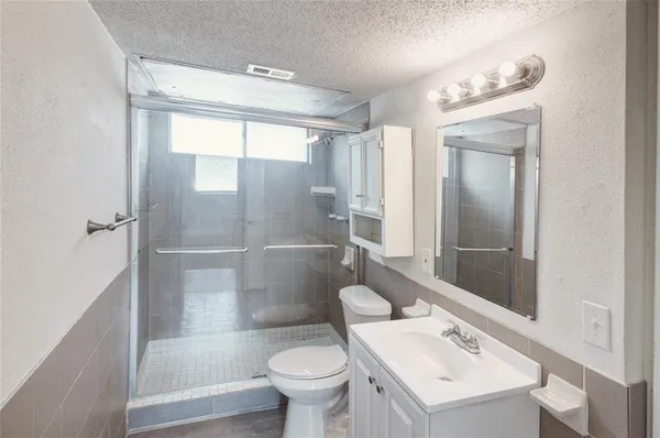 a white toilet sitting next to a bathroom sink