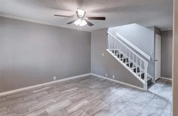 a view of a hallway with wooden floor and a kitchen