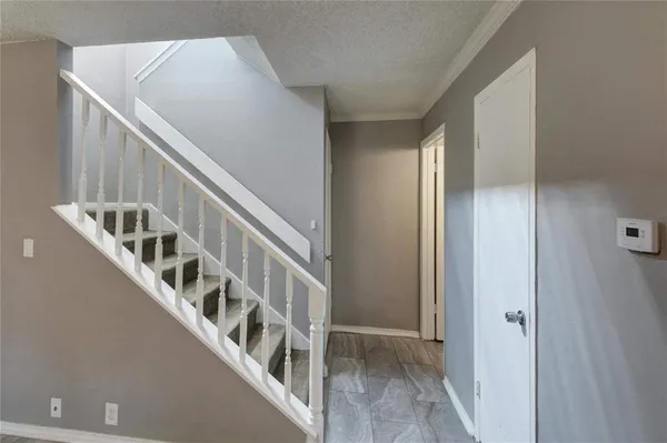 a kitchen with a refrigerator sink and cabinets