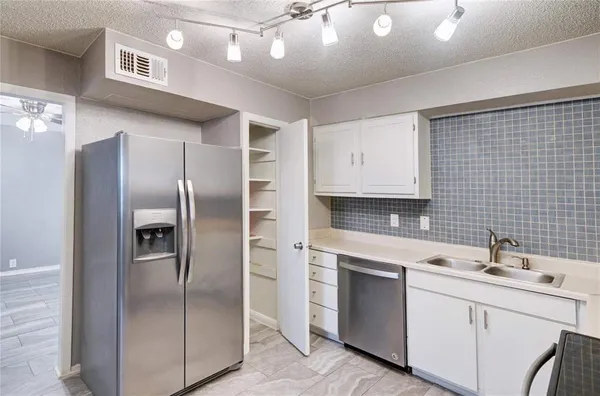 a kitchen with a sink stainless steel appliances and cabinets